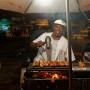 Snack bar owner in Porto Seguro, Bahia (he blow-dries little chicken hearts, a speciality there), Brazil